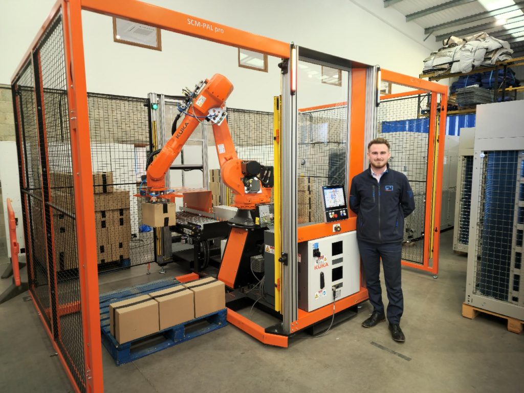 Marcus Worrall in front of PalPro robotic system