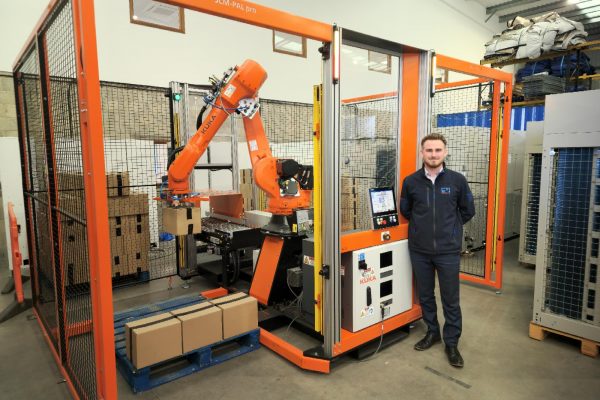 Marcus Worrall in front of PalPro robotic system